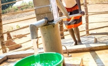 Mbugu Feza fetches water at the water pump in the Luba village, constructed with the support of Concern Worldwide within the framework of the DRC WASH. Photo: Concern Worldwide.