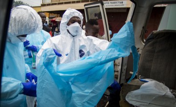 Members of burial team 5 prepare to remove a body from a home in Freetown. Photo taken by Kieran McConville / Concern Worldwide.