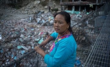 Sua Tamang overlooks the devastation caused by the earthquake in Dolakha District. Credit: Brian Sokol/Concern Worldwide.