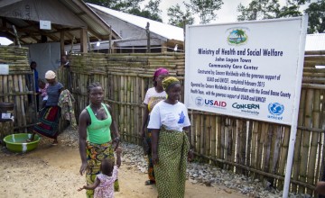 Women leaving the Community Care Centre in John Logan Town, Grand Bassa County, Liberia The centre, built by Concern Worldwide, was designed to treat Ebola patients but has been transformed into a general health centre. Photo taken by Kieran McConville / Concern Worldwide.