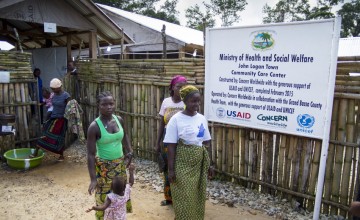 Women leaving the Community Care Centre in John Logan Town, Grand Bassa County, Liberia The centre, built by Concern Worldwide, was designed to treat Ebola patients but has been transformed into a general health centre. Photo taken by Kieran McConville / Concern Worldwide. 