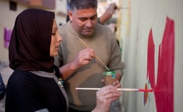 Tarek and Zeinah attend an art workshop with refugee families at a Concern supported Collective Centre in Northern Lebanon in December 2015. Zeinah and Tarek now live with their three children and two other families. Photo: Panos Pictures/Concern Worldwide.