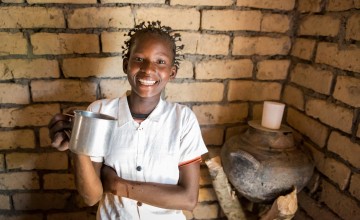 Liliana from Mulombwa in DRC proudly holds a cup of clean water. The DRC WASH Consortium worked with her community to raise awareness about water, sanitation and hygiene and build a water pump in the village. Photo: Kieran McConville/Concern Worldwide. 