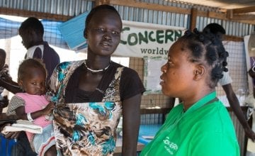Nyakong Kwach and her 12 month old daughter, Nyadhabitat, talk with Concern nutritionist, Tracy Dube at the Concern nutrition centre in a refugee camp in Juba, South Sudan. They took shelter here after fighting broke out in July 2016. The centre is currently seeing between 60 and 70 new cases a week. Photo: Kieran McConville/Concern Worldwide.