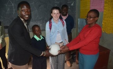 A ball from Michael Darragh McAuley is presented to head teacher Mrs Mary Nabowa and class teacher of class five in Dandora IV prep school. Photo: Francis Mwangi/Concern Worldwide