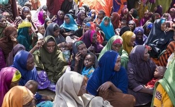 Displaced families collect SIM cards for emergency cash phone transfers from Concern Worldwide at a displacement camp in Mogadishu, Somalia. Numbers of people being displaced by drought and hunger are increasing steadily. Photo: Kieran McConville, March 2017.