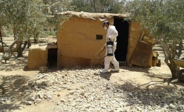 Member of the Concern team in Syria spraying a building in order to control the spread of pests and insects. The bombing of buildings and the breakdown of municipal systems has resulted in a build-up of dust and dirt for pests to thrive in. Photo: Concern Worldwide. 