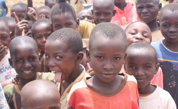 Children from Kirundo province stand around at the distribution of materials for the construction of kitchen gardens. Photo: Alexandre Niyongabo/Concern Worldwide.