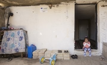 Oula* has been a refugee in Lebanon all her life. She sits on the doorstep of a former stable which has been transformed into safe home thanks to the Concern team. Photo: Chantale Fahmi/Concern Worldwide 2017.