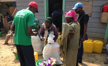Lumoo Faida, left, receives a relief kit at Concern’s base in Masisi, Democratic Republic of Congo. Photo taken by Silvia de Faveri/Concern Worldwide.