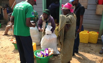 Lumoo Faida, left, receives a relief kit at Concern’s base in Masisi, Democratic Republic of Congo. Photo taken by Silvia de Faveri/Concern Worldwide.