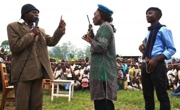 Assurance Kilonpfu, left, plays the village chief at a performance in Mahanga village, Democratic Republic of Congo. Photo taken by Charlie Walker/Concern Worldwide.