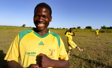 Mwale Chibiliro (18) in sports kit and football boots from Concern Worldwide.