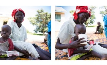 Yak sits with his mother, Achara, and eats ready-to-eat therapeutic foods at Mayom Health Care Unit in Aweil West County, Northern Bahr el Gazal, South Sudan. Photo: Crystal Wells/Concern Worldwide.