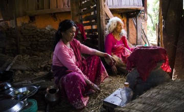 Two women cook in a house left standing after the Nepal earthquake. Photo taken by Crystal Wells/Concern Worldwide