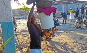 A woman in La Gonave, Haiti, picks up aid after Hurricane Matthew. Credit: Leguenson Jules-Saint.