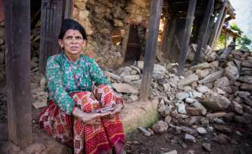 Tulasa Aryal sits on the porch of her earthquake-ravaged home in Bakrang, a village near the epicenter of the earthquake. Photo taken by Crystal Wells/Concern Worldwide.