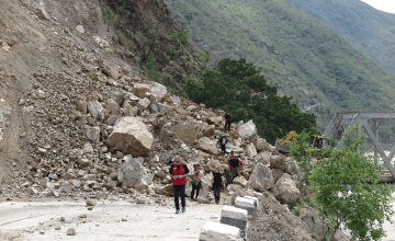 Bulldozers work to re-open a bridge at Khurkot, Ramechhap. Photo taken by Helvetas.