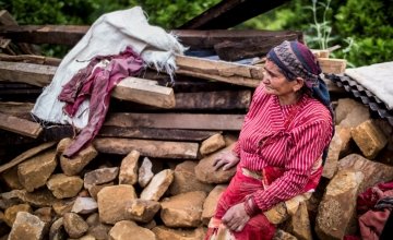 In the Nepalese village, Kukhreta, a woman sits on the rubble of her recently-destroyed home. Photo taken by Crystal Wells/Concern Worldwide