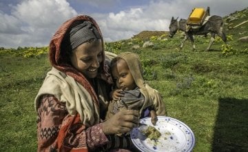 Mavema Mohammed, 25, and her 23-month-old son receive supplemental food at a health post in the Amhara Region of Ethiopia, 2013. Photo: Jiro Ose / Concern Worldwide.