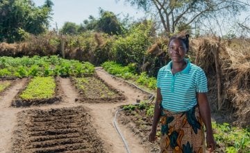 Queen, 36, a participant in Concern's RAIN programme stands in her vegetable garden. She has received tools, seeds, livestock and training. Photo: Gareth Bentley / Concern Worldwide.