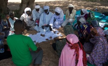 A community group discuss the results of the vote on impact and frequency of hazards in order to prioritise the most important ones in Tcharow, Chad