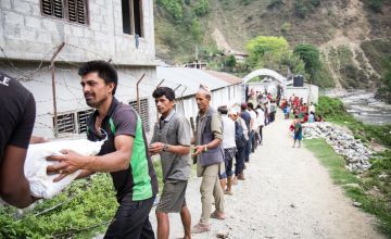 Supplies are unloaded at a Rural Reconstruction Nepal (RRN) and Concern Worldwide team distribution in Talamarang (VDC), Sindhupalchok district, Nepal. Photo by Crystal Wells, 2015.