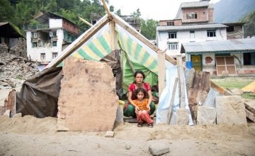 Chameli Darji sits with her youngest daughter, Apita, in their makeshift shelter in Talamarang in Sindhupalchok District, Nepal, one of the hardest hit areas by the 7.8-magnitude earthquake that hit the country on April 25th. Photo taken by Crystal Wells / Concern Worldwide.