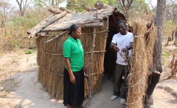 Jean Claude Mwilambwe shows to a Concern officer his latrine with the hand-wash installation. Photo: Silvia De Faveri.