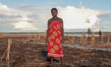 Farmer Malita (25) inspects whats left of her field after extensive flooding. The entire crop has been ruined just one month before harvest. Photo: Gavin Douglas/Concern Worldwide