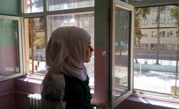 Hasna looks from her classroom window during a break from her studies in a Temporary Education Centre for Syrian refugees in Turkey. Photo: Concern Worldwide.