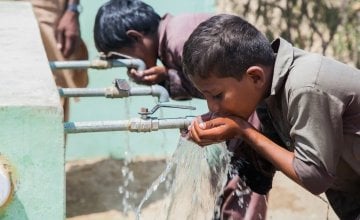 Young boys enjoying a drink at a newly installed water system in Umerkot, Pakistan. Photo: Concern Worldwide. 