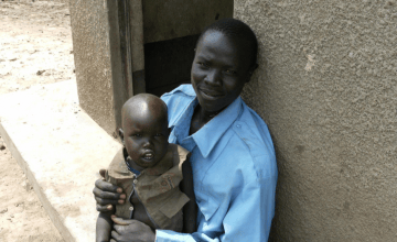 Mark Lodim, a member of the crop husbandry group in Concern's Vocational Skills Training programme with his nephew in Lotome, Karamoja, Uganda. Photo: Finola Mohan / Concern Worldwide.