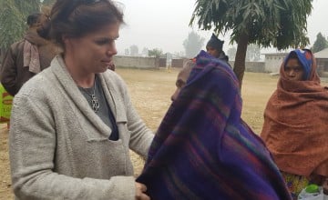 Concern Country Director Eileen Morrow helping to distribute blankets to vulnerable beneficiaries. Photo: Concern Worldwide. 