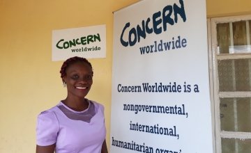 Mabrat Abdulai, Learning and Knowledge Management outside Concern’s office in Tonkolili. Photo credit: Carlos Velazquez.