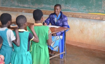 Mercy Mwadula marking her learners exercise in class as they await their turns to be marked. Photo: Concern Worldwide.