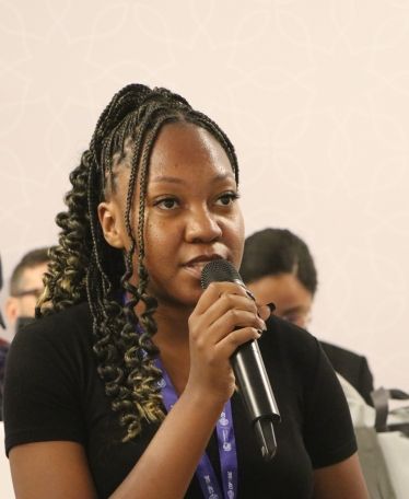 Dorothy Kazombo Mwale speaking into microphone at COP28