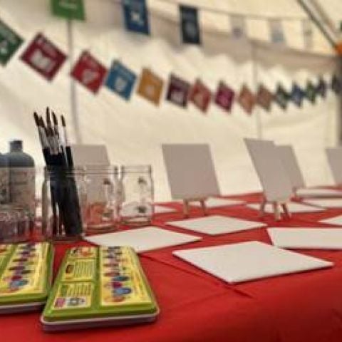 Arts supplies on table in tent