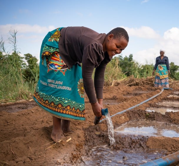 A treadle pump helps to irrigate crops in Malawi