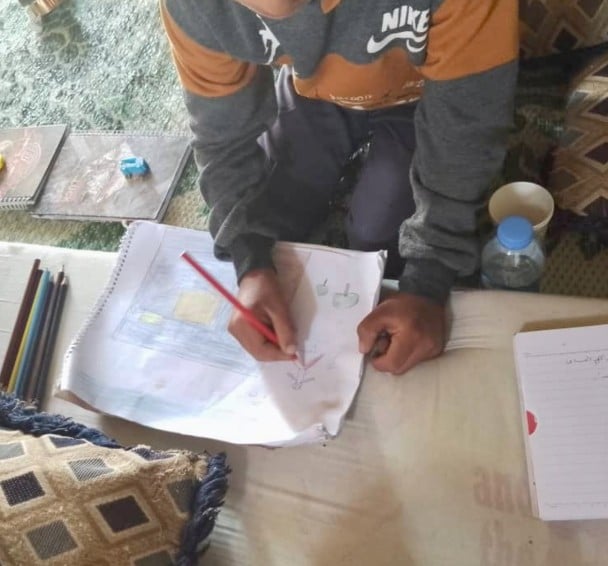 Hani (name changed) drawing on his homework