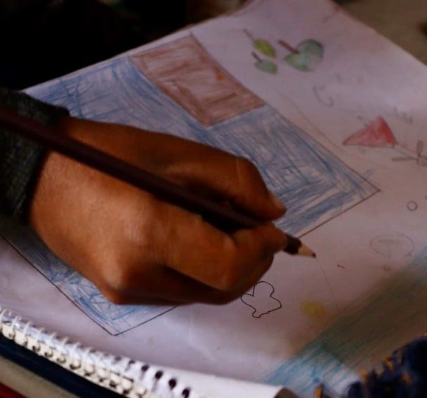 Hani (name changed) drawing on his homework