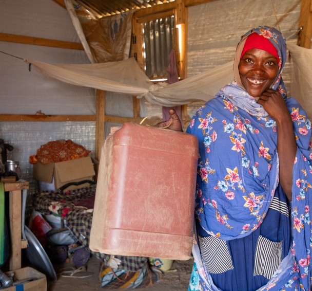 Hamila shows jerrycan provided by Concern