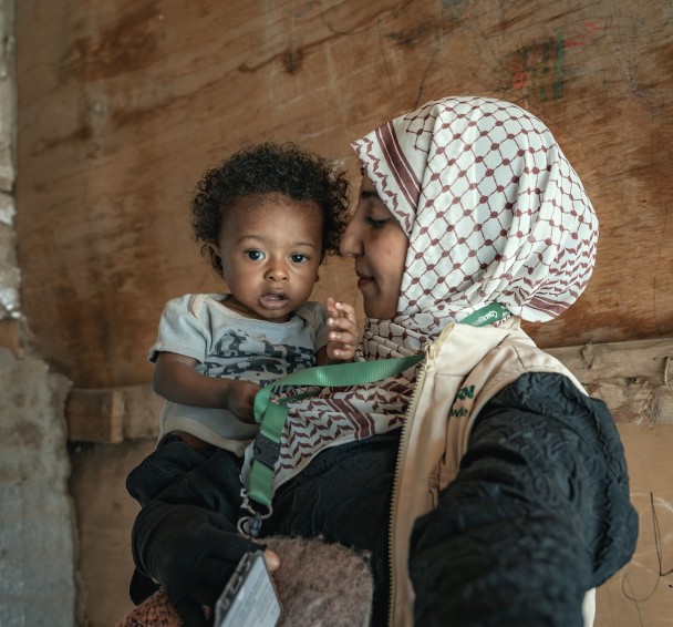 Concern health worker holding baby Basam
