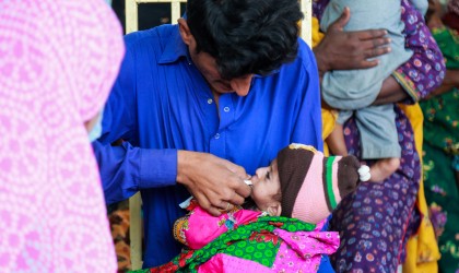 A father feeding his baby at a mobile clinic.