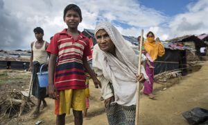A young Rohingya boy and his grandmother in a refugee camp