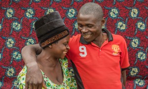 Man smiling at wife with arm around her