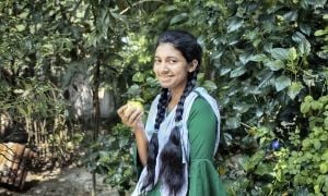 Fifteen year old Sharmin Akter is eating guava, which is a nutritious fruit. She often participates in group discussions in the yard meeting conducted by Concern Worldwide and its partner organizations to gain knowledge about healthy food, health and hygiene, gender, and social safety issues. The Collective Responsibility, Action, and Accountability for Improved Nutrition (CRAAIN) project have educated them to act right about nutrition and safeguarding health. Photo: Mohammad Rakibul Hasan/Concern Worldwide