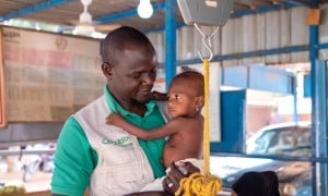 Concern&#039;s Early-Child Development Officer Mahamadou Boubakar helps healthcare staff at the Concern-supported intensive nutritional recovery centre (CRENI) at Tahoua Hospital carry out an initial assessment of 13-month-old Nana-Aicha who is severely malnourished. (Photo: Darren Vaughan/Concern Worldwide)