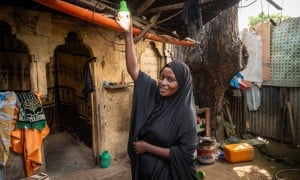 Idil* turning on the solar light she received as part of the Green graduation programme by Concern. (Photo: Mustafa Saeed/Concern Worldwide)