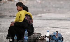 A boy and his mother after leaving Lebanon